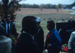 Actor Joel Flullen (Uncle Rob), wearing glasses, and other actors and production crew filming Sarah Winger‚Äôs funeral scene.