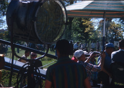 Production Crew and acting cast taking a break between scenes by production equipment