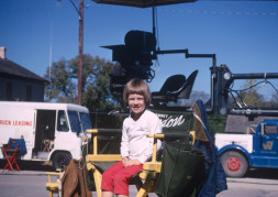Young boy seated in Gordon Parks‚Äô director‚Äôs chair.