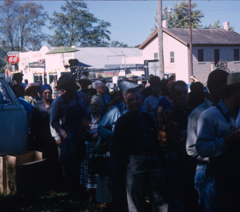 Actors, crew, and others in line, likely for food, in downtown Fort Scott, Kansas.