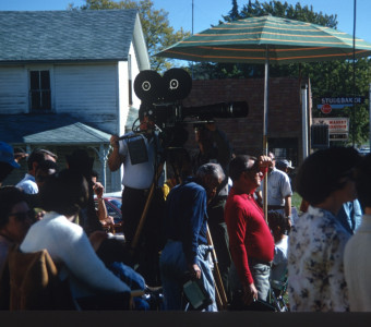 Production crew filming a scene with community members looking on in downtown Fort Scott, Kansas.