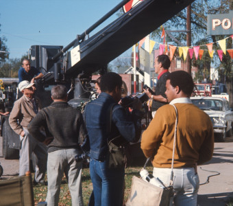 Gordon Parks' eldest son, Gordon Parks Junior, holdS a camera as crew film a scene in downtown Fort Scott, Kansas.