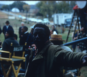 Director Gordon Parks pointing something out to crew member.