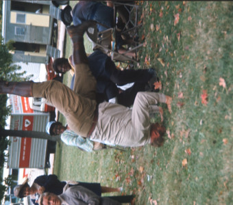 Actor Dana Elcar (Kirky) attempting a headstand in front of fellow actors.