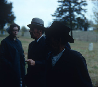 Actor Malcolm Atterbury (Silas Newhall), center, and fellow actors around filming of funeral scene.