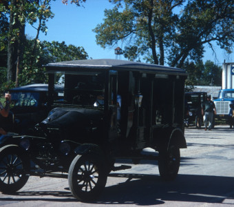 Crew members, black buggy, and production vehicles.