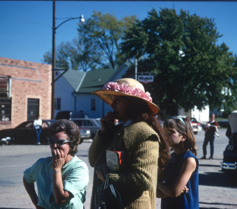 Women standing in downtown Fort Scott, Kansas. One is holding a copy of The Learning Tree.