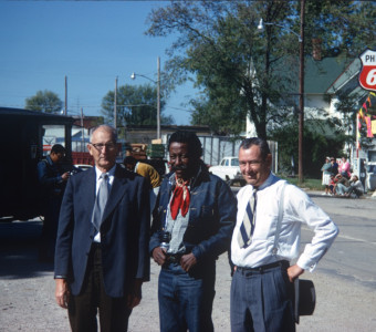 Director Gordon Parks (center) and two actors pose for a photograph on set in downtown Fort Scott, Kansas.