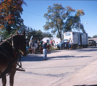 Horses and wagons with onlooks in downtown Fort Scott, Kansas during filming.