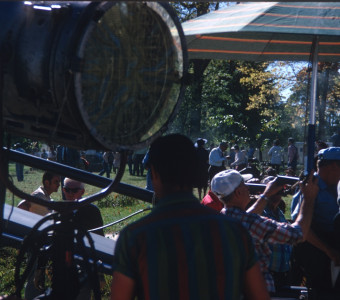 Production Crew and acting cast taking a break between scenes by production equipment