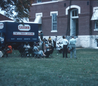 Actors and crew members on a break outside of the courthouse used for the trial scene.