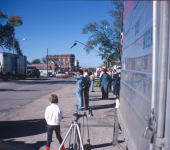 Actor Kyle Johnson (Newt Winger) points as production crew and equipment lines both sides of the street in downtown Fort Scott, Kansas.