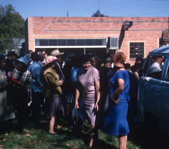 Acting cast mingling in front of a brick building in downtown Fort Scott, Kansas.