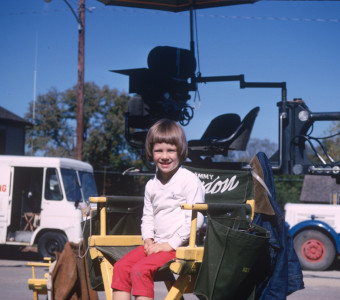 Young boy seated in Gordon Parks‚Äô director‚Äôs chair.