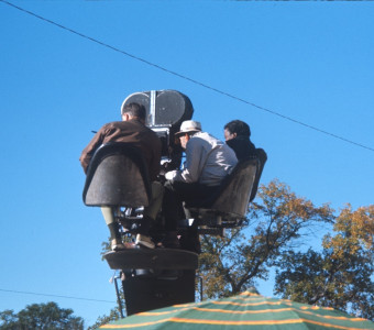 Director Gordon Parks, right, and two production crew members filming from above by the Phillips 66 gas station.