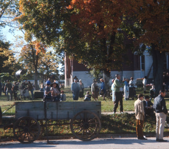 Cast and crew mingling on the lawn outside of courthouse building used for trial scene.