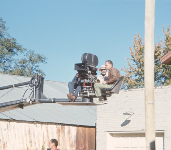 Production crew filming from above in front of a brick building in downtown Fort Scott.