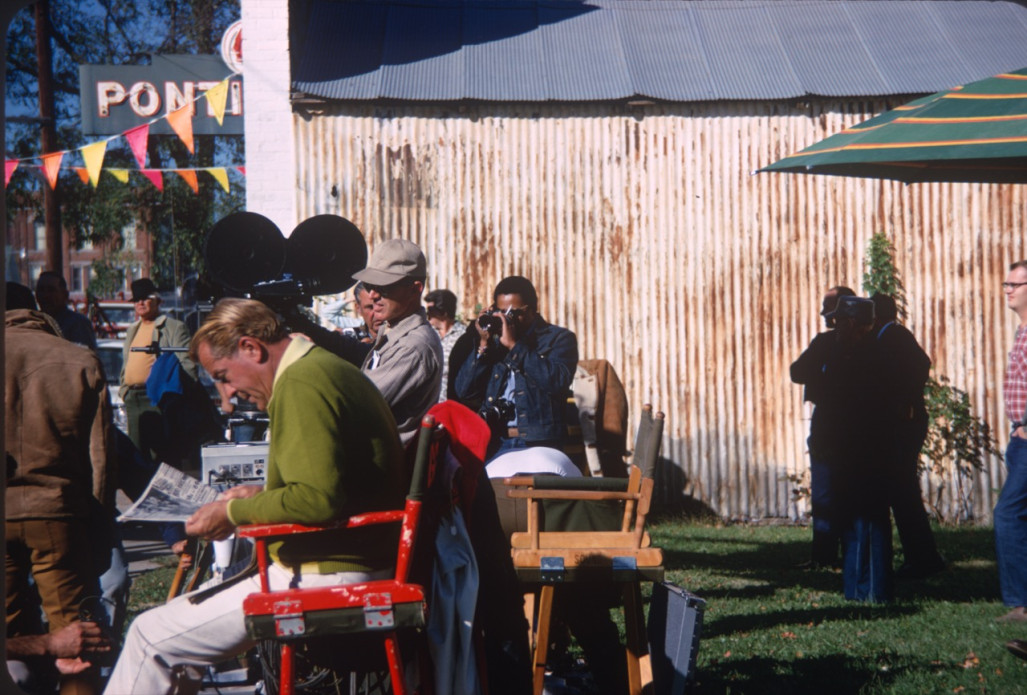 Production crew in downtown Fort Scott, Kansas. Gordon Parks, Jr. (Center) takes a photograph.