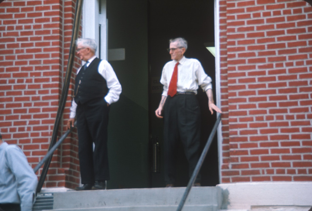 Actors exiting the courthouse from the trial scene.