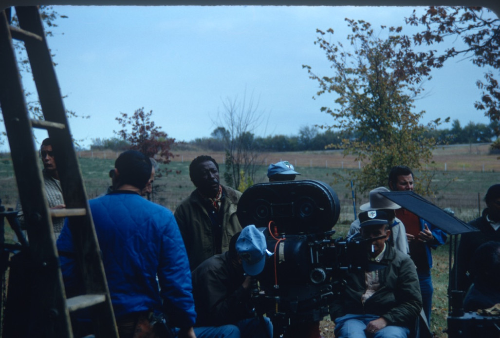 Director Gordon Parks, behind camera in green jacket, and production crew filming in rural area outside of Fort Scott, Kansas.