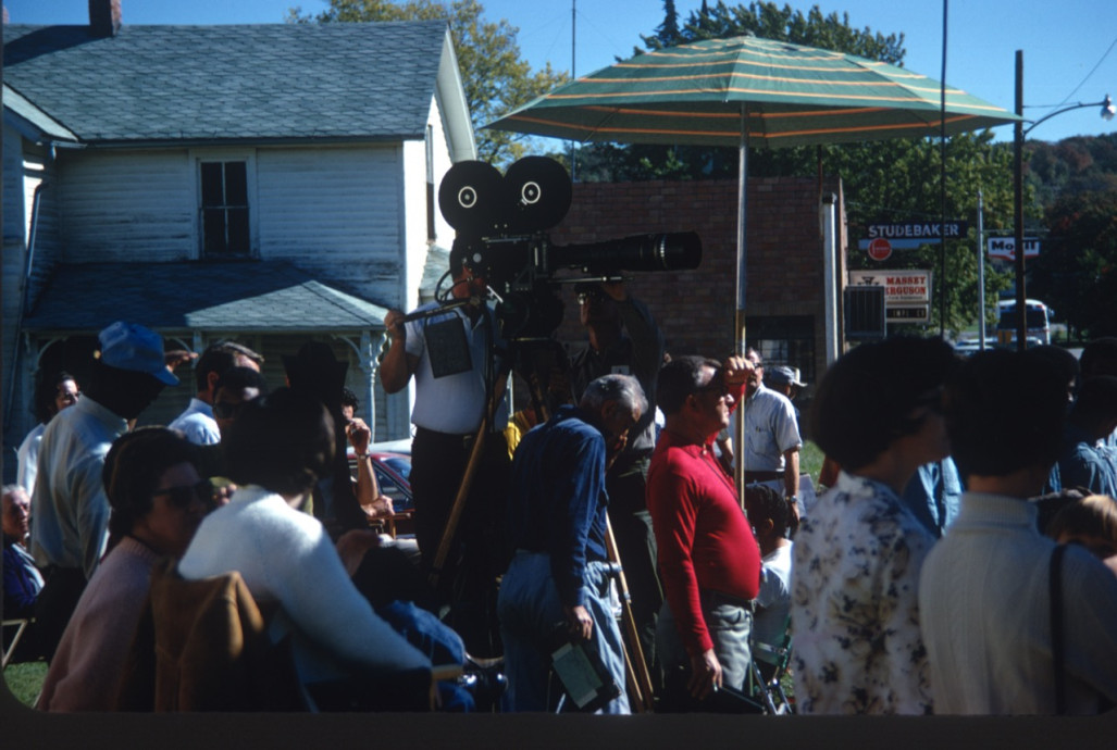 Learning Tree crew and community gathered around production equipment Production crew filming a scene with community members looking on in downtown Fort Scott, Kansas.