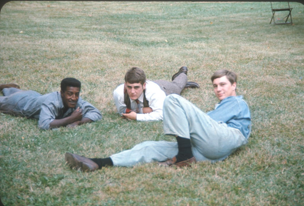 Actors laying down in the grass.