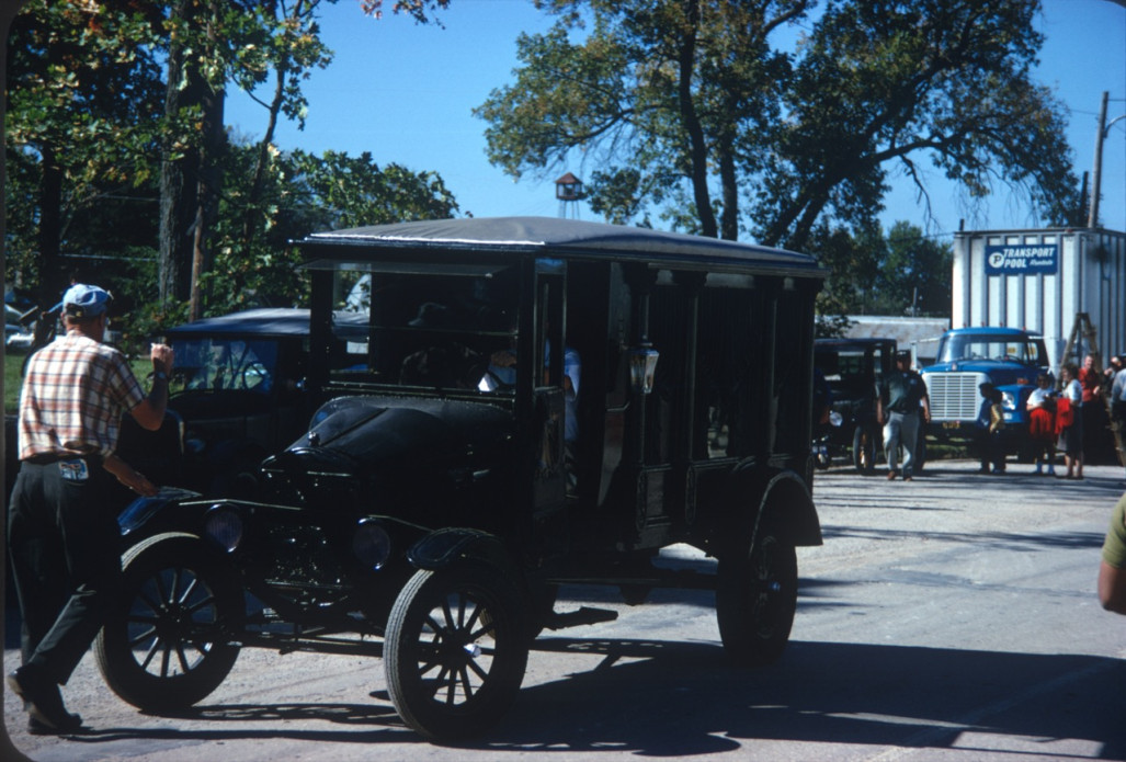 Crew members, black buggy, and production vehicles.