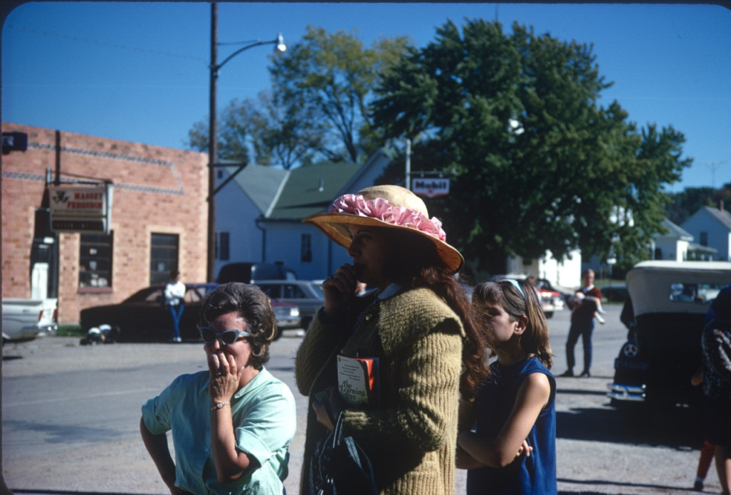 Women standing in downtown Fort Scott, Kansas. One is holding a copy of The Learning Tree.