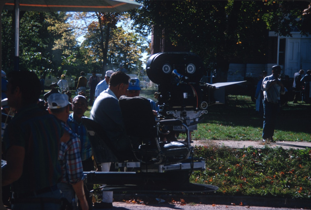 Crew filming a scene with camera outside of the courthouse used in the trial scene. Actor Kyle Johnson (Newt Winger) stands in the background (left, mustard colored sweater).