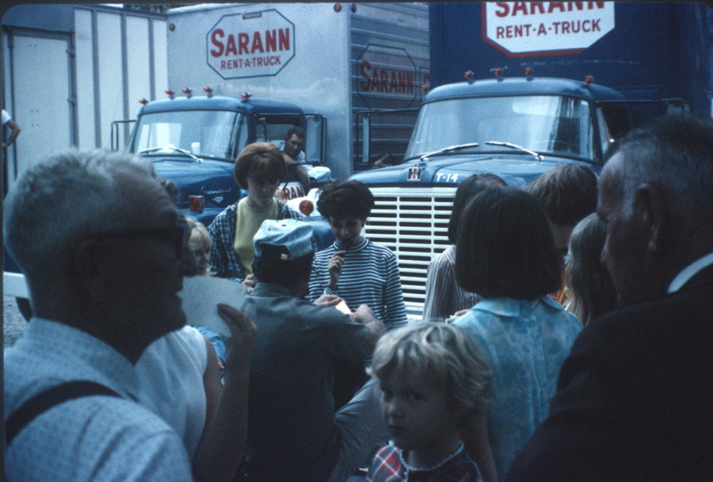 Cast, Crew, and others in front of production vehicles.