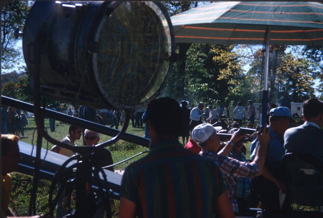 Production Crew and acting cast taking a break between scenes by production equipment