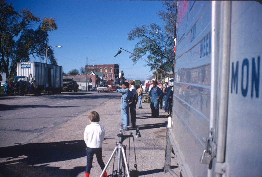 Actor Kyle Johnson (Newt Winger) points as production crew and equipment lines both sides of the street in downtown Fort Scott, Kansas.