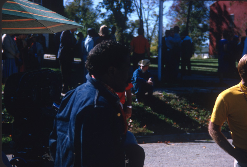 Director Gordon Parks in front of cast and crew members.