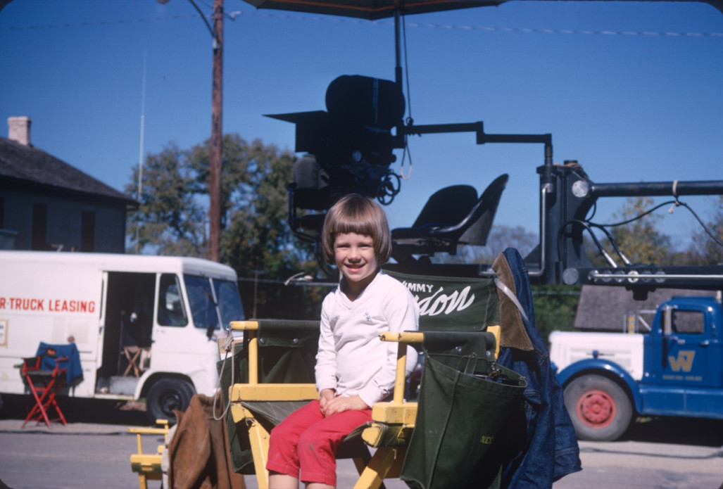 Young boy seated in Gordon Parks‚Äô director‚Äôs chair.