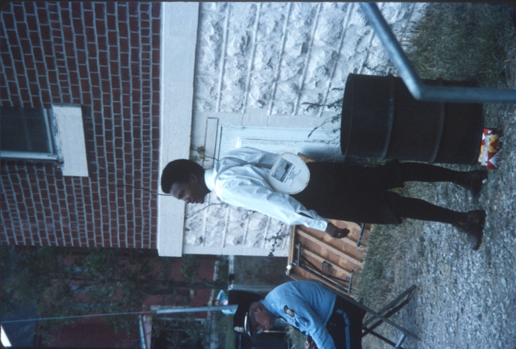 Actor Kyle Johnson (Newt Winger) standing next to garbage can outside of courthouse building from trial scene.